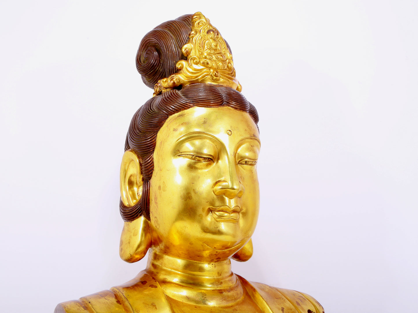 A solemn gilt bronze statue of Guanyin