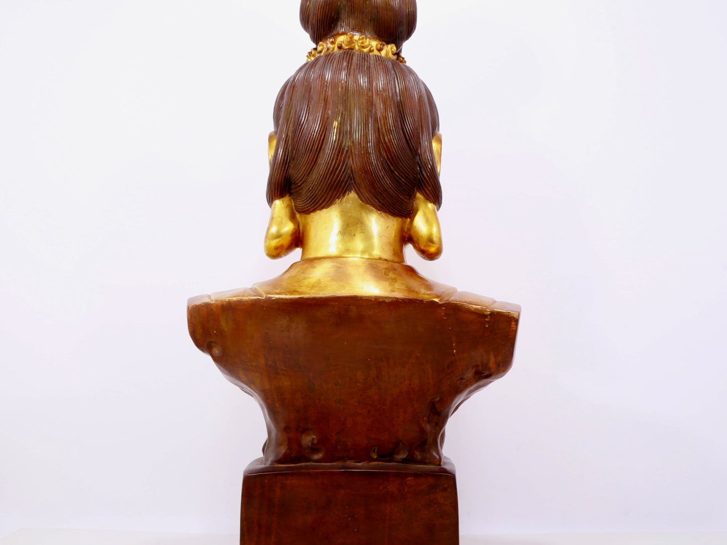 A solemn gilt bronze statue of Guanyin