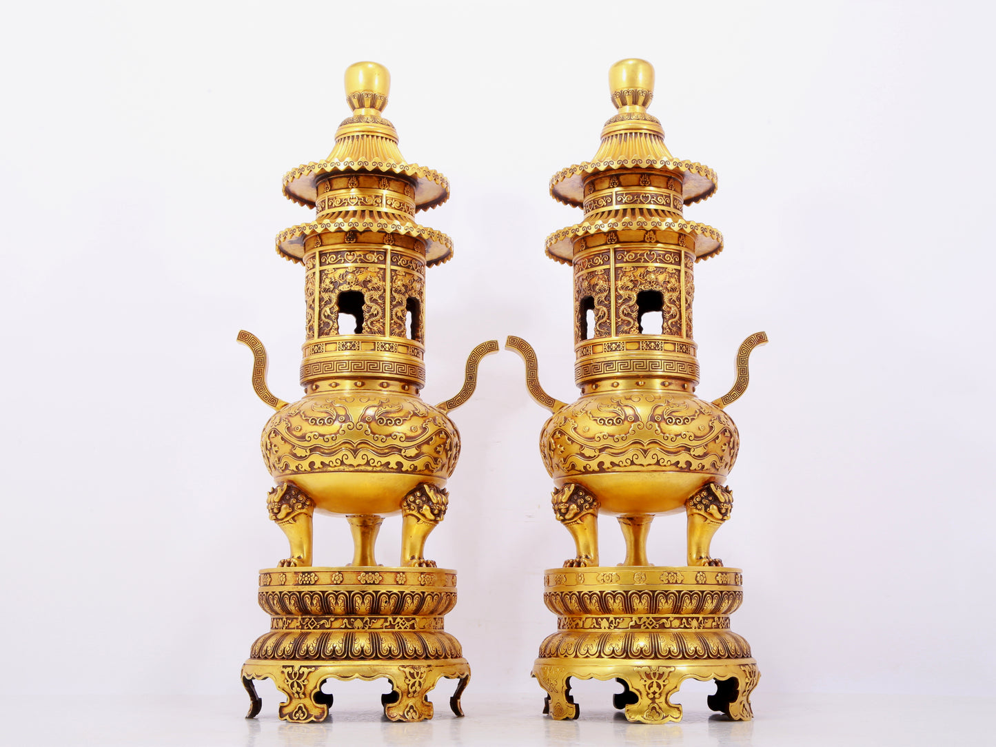 A pair of exquisite gilt copper three-legged incense burners with animal faces and two ears