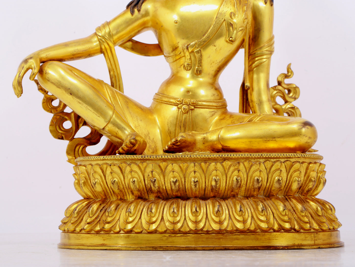 A solemn gilt bronze statue of Guanyin