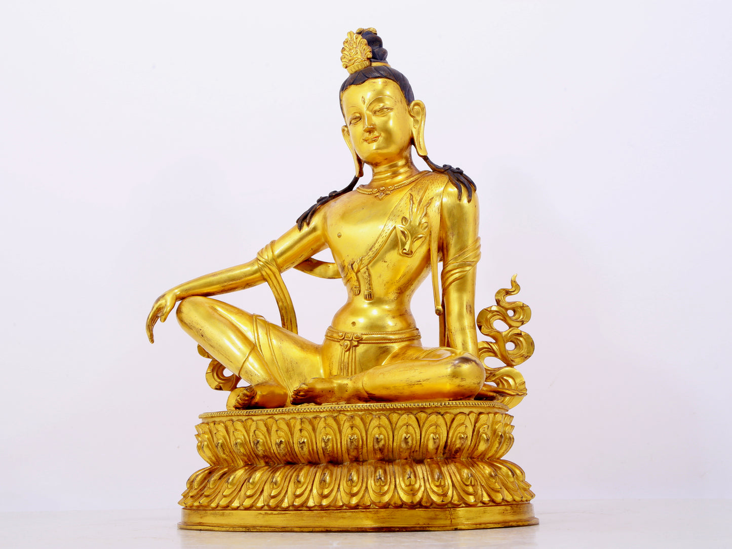 A solemn gilt bronze statue of Guanyin