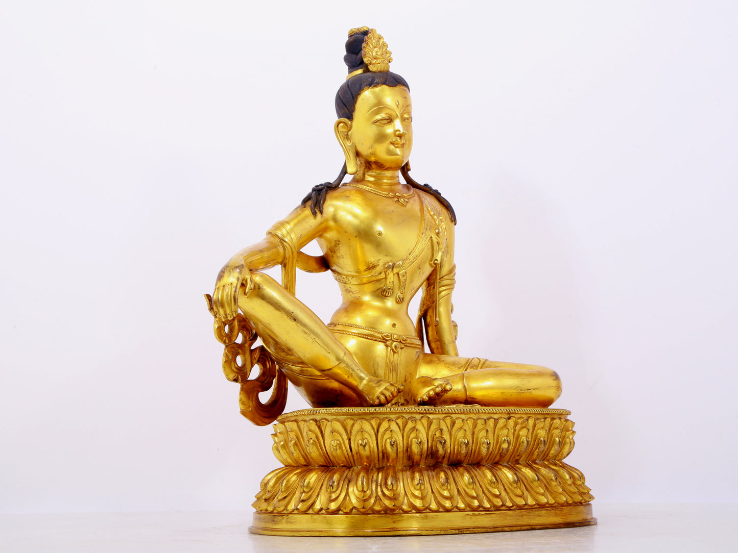 A solemn gilt bronze statue of Guanyin