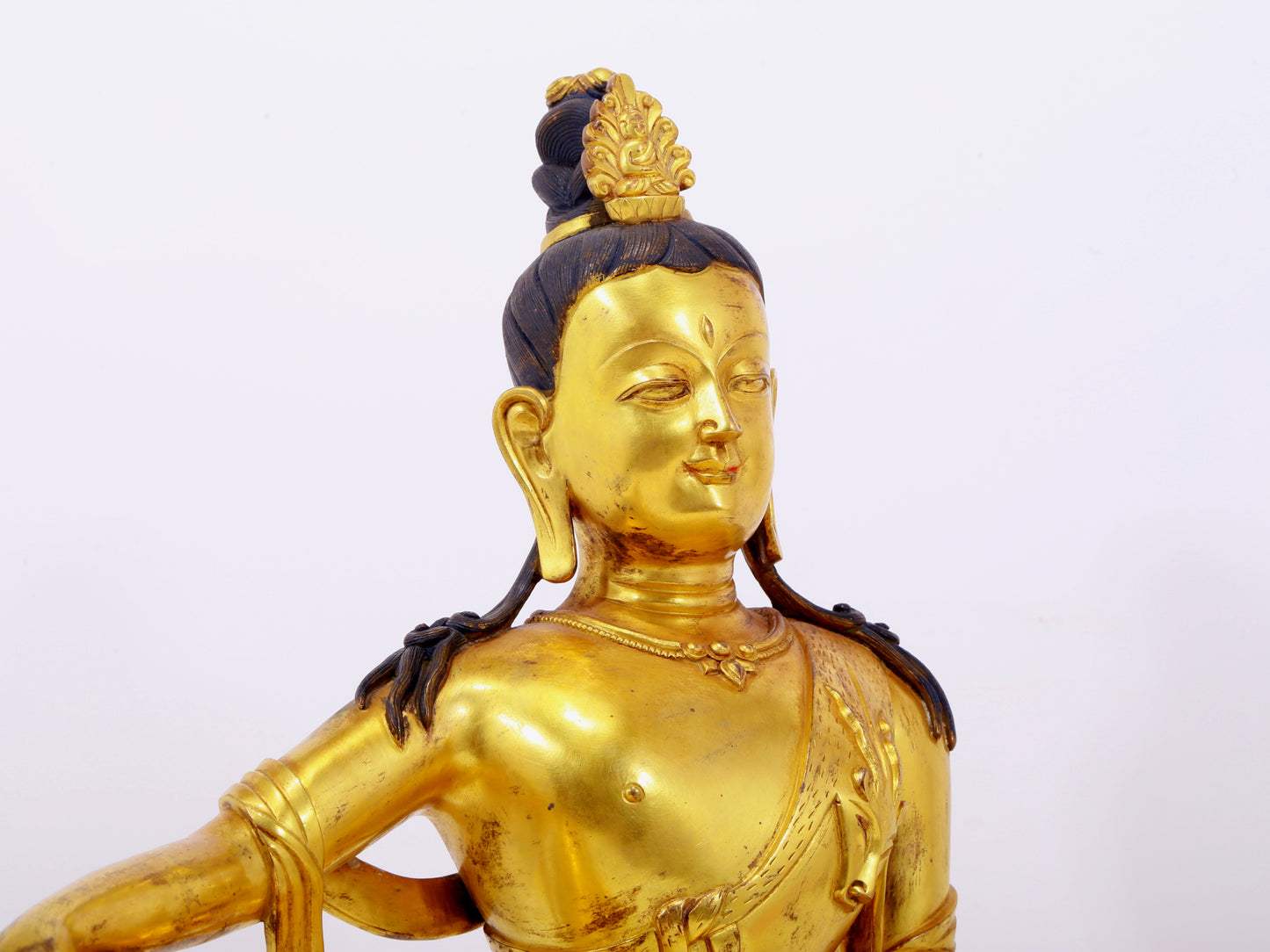 A solemn gilt bronze statue of Guanyin