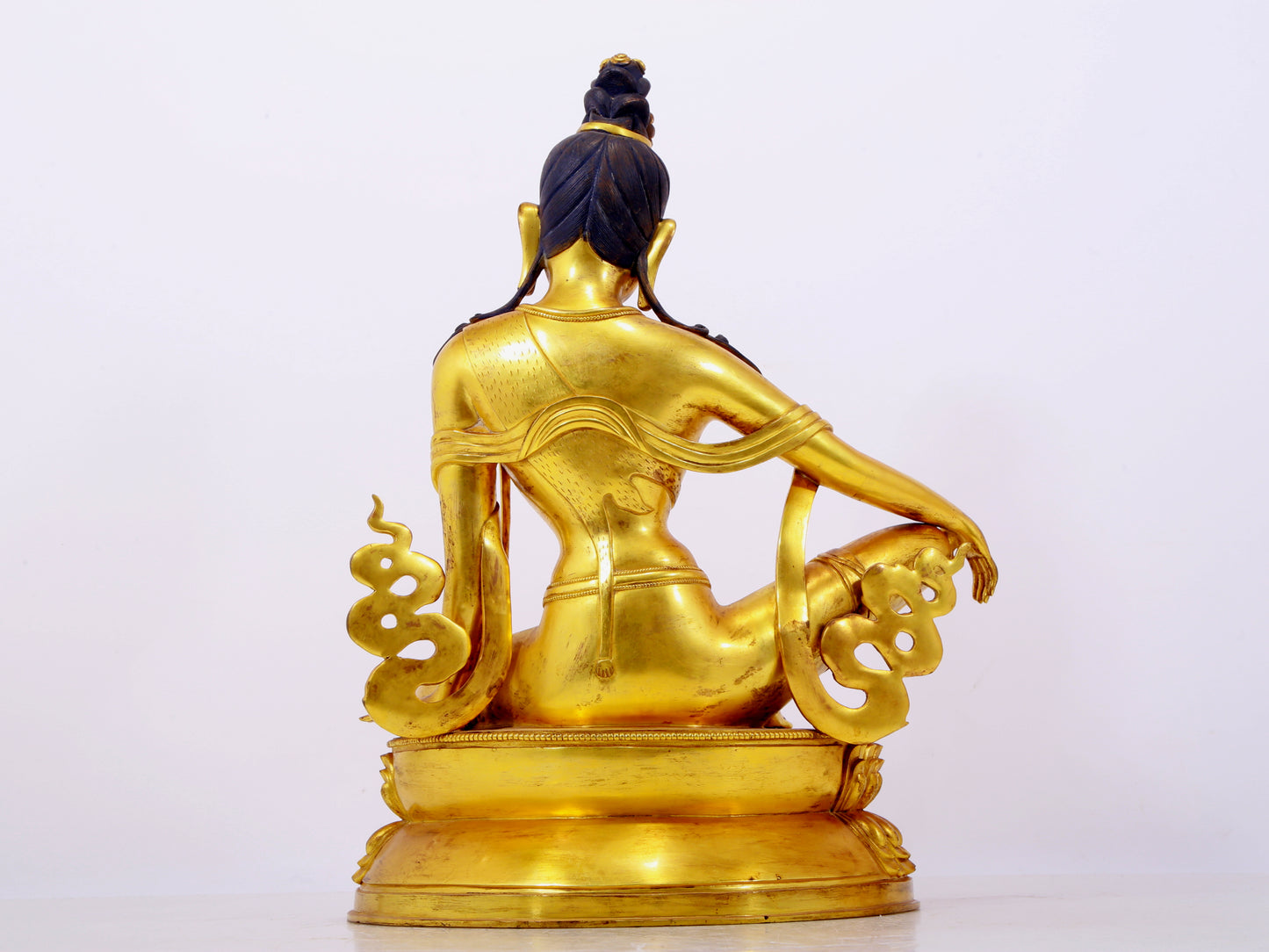 A solemn gilt bronze statue of Guanyin