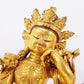 A solemn gilt bronze statue of Guanyin