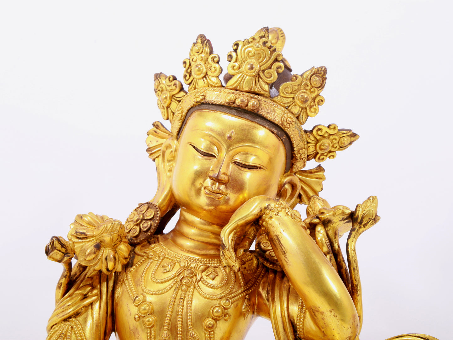 A solemn gilt bronze statue of Guanyin