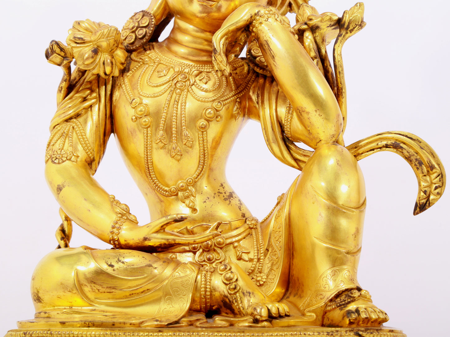 A solemn gilt bronze statue of Guanyin