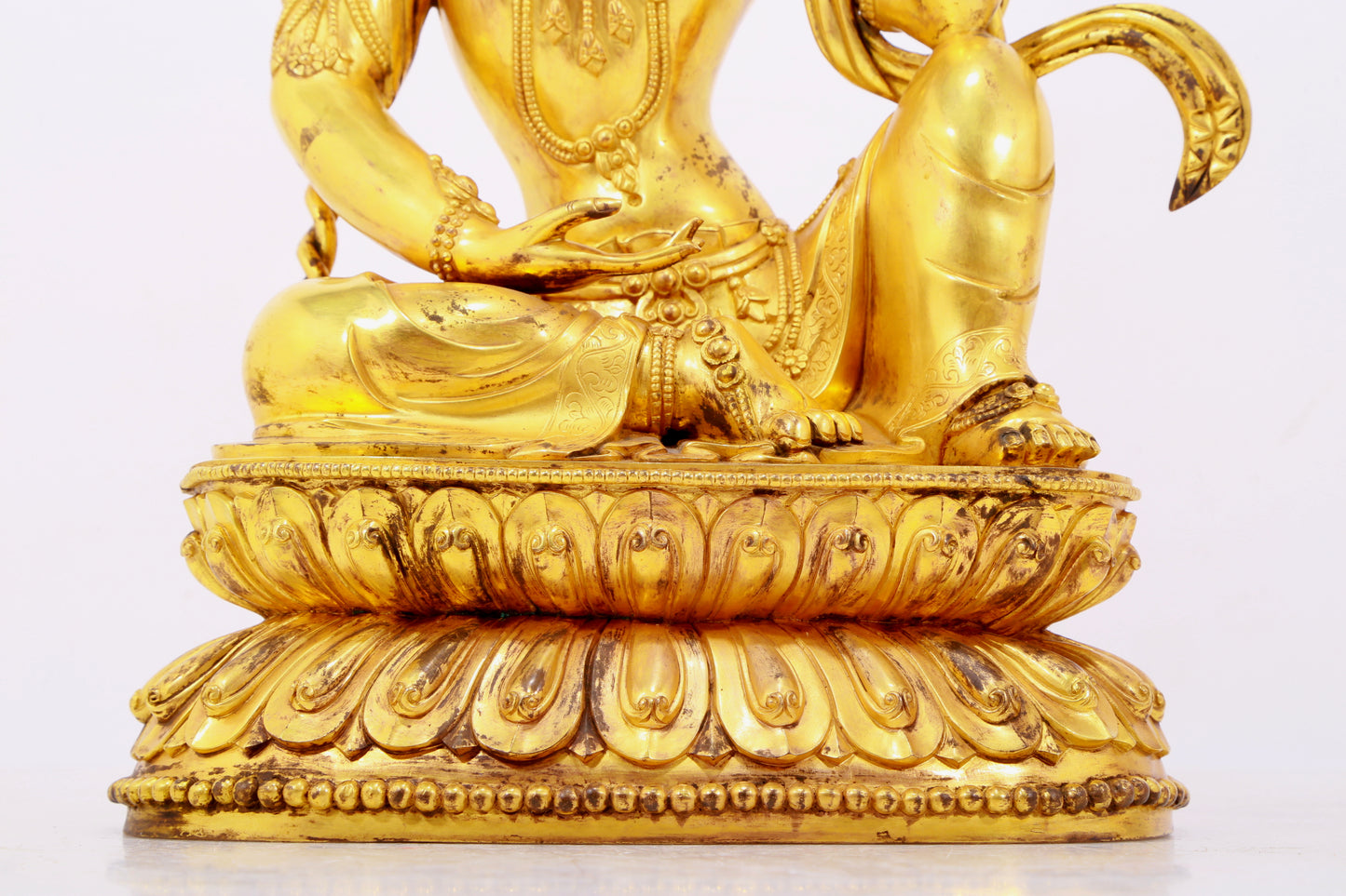 A solemn gilt bronze statue of Guanyin