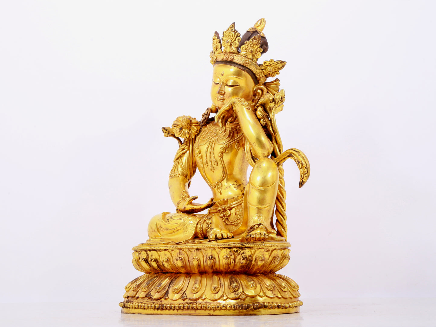 A solemn gilt bronze statue of Guanyin