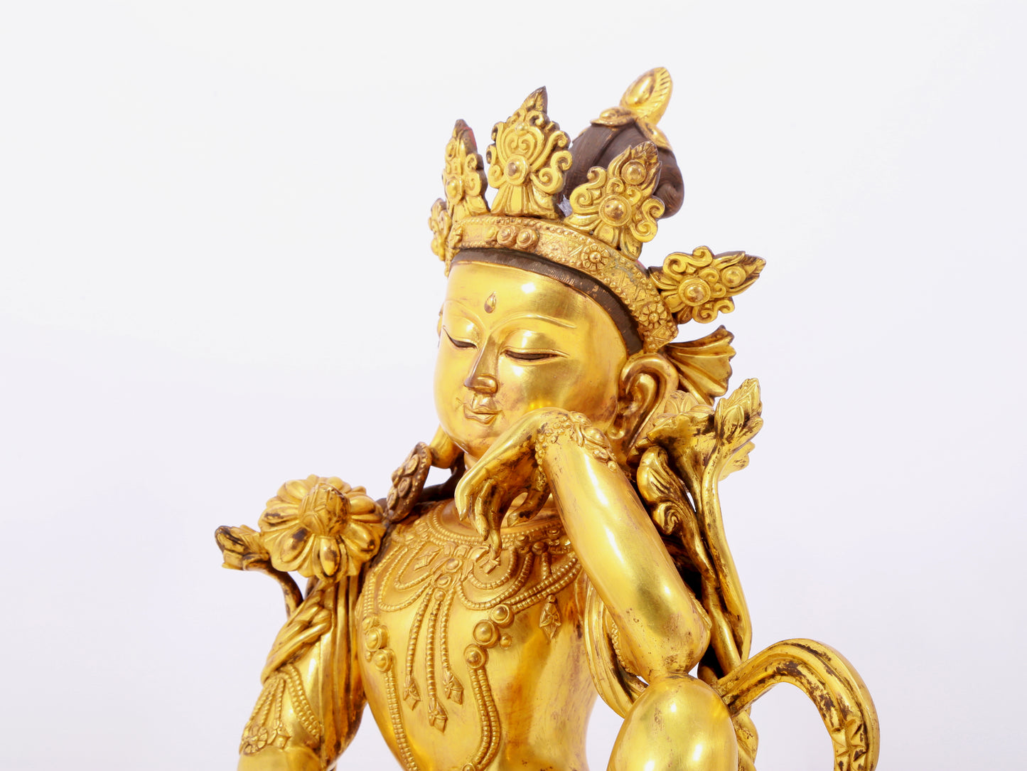 A solemn gilt bronze statue of Guanyin