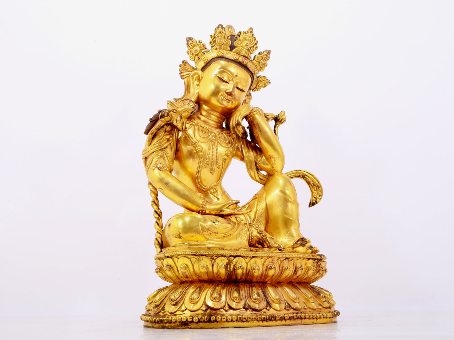 A solemn gilt bronze statue of Guanyin