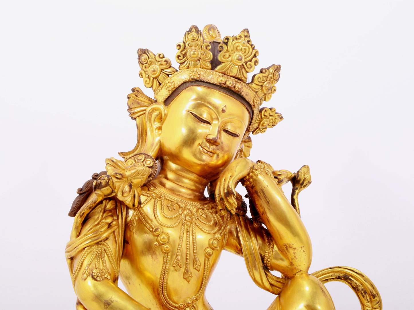 A solemn gilt bronze statue of Guanyin