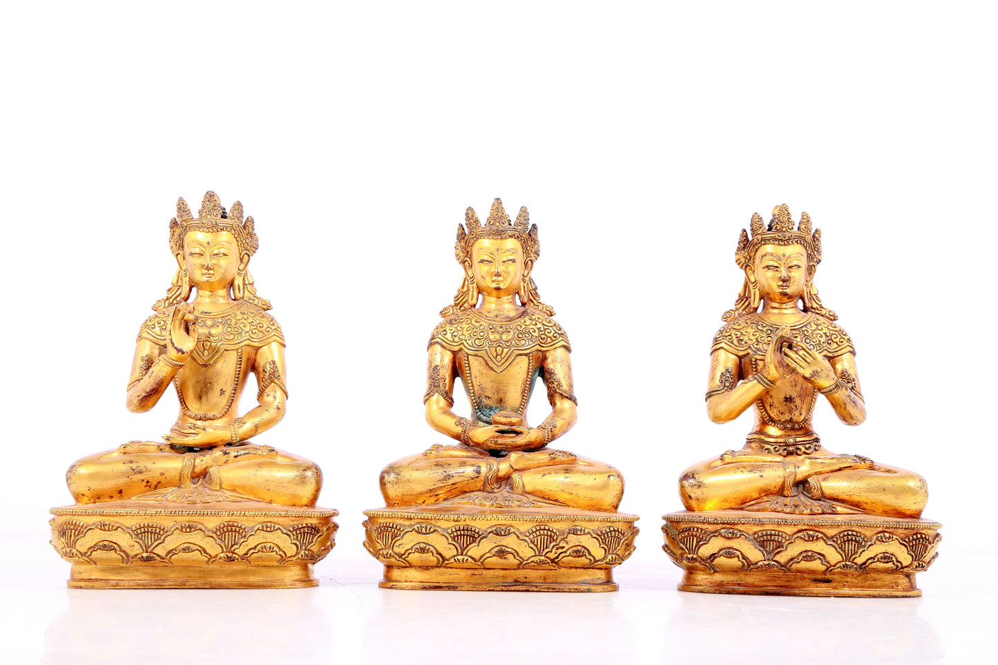 Three statues of a solemn gilt-bronze Bodhisattva