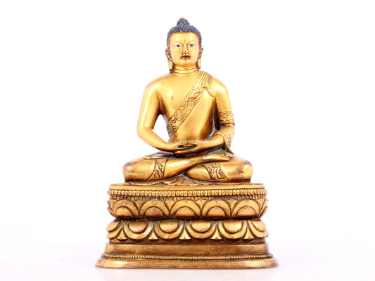 A solemn gilt bronze statue of Sakyamuni