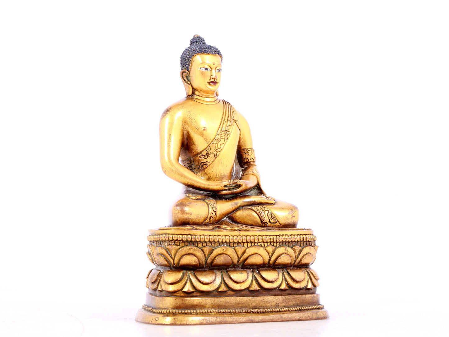 A solemn gilt bronze statue of Sakyamuni