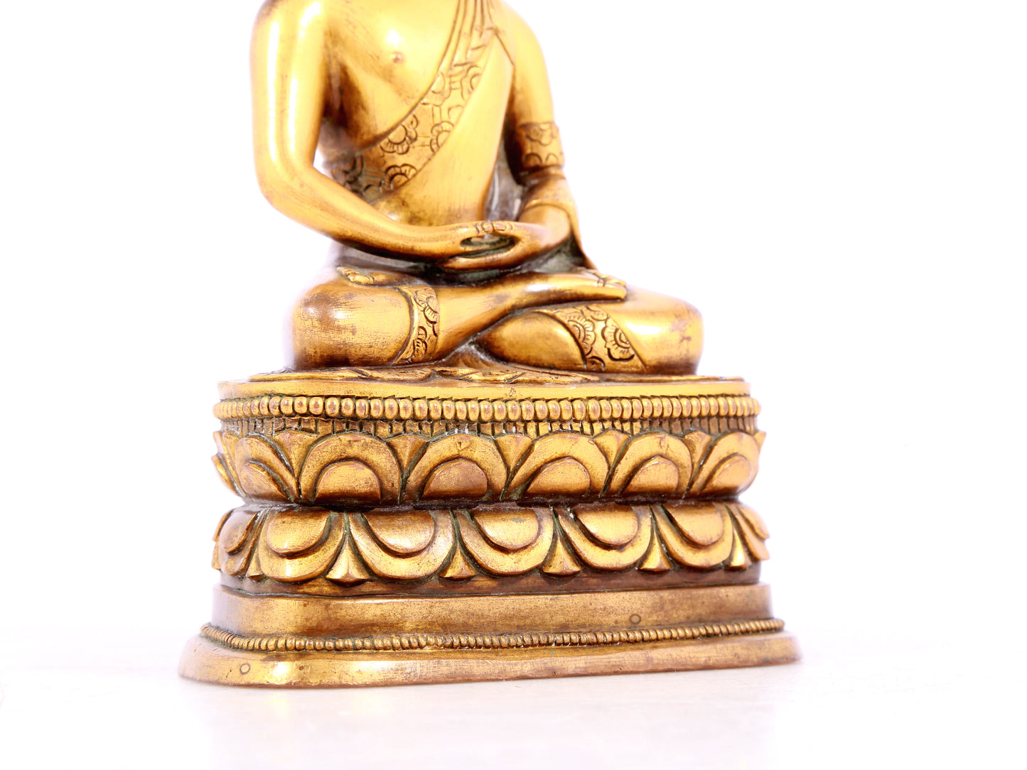 A solemn gilt bronze statue of Sakyamuni