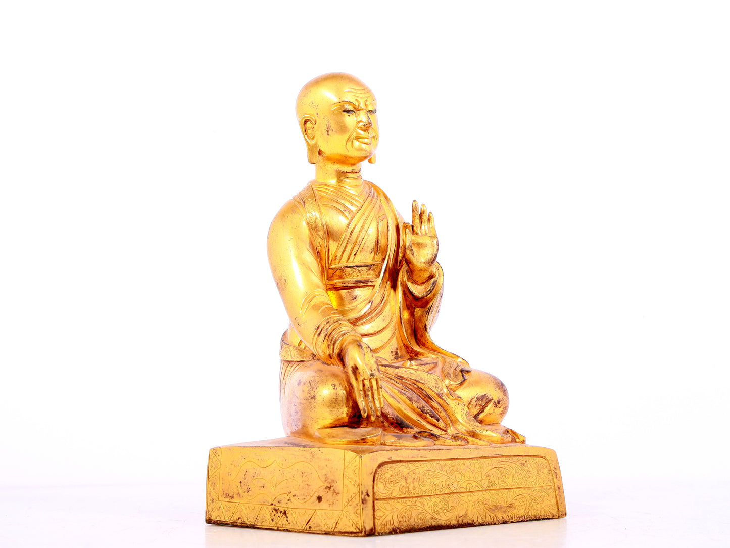 A solemn gilt bronze statue of guru