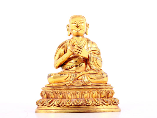 A solemn gilt bronze statue of guru