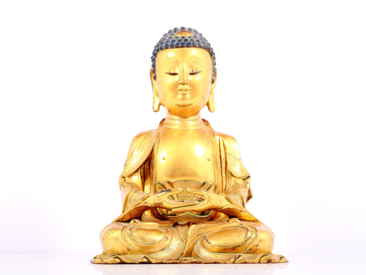 A solemn gilt bronze statue of Sakyamuni