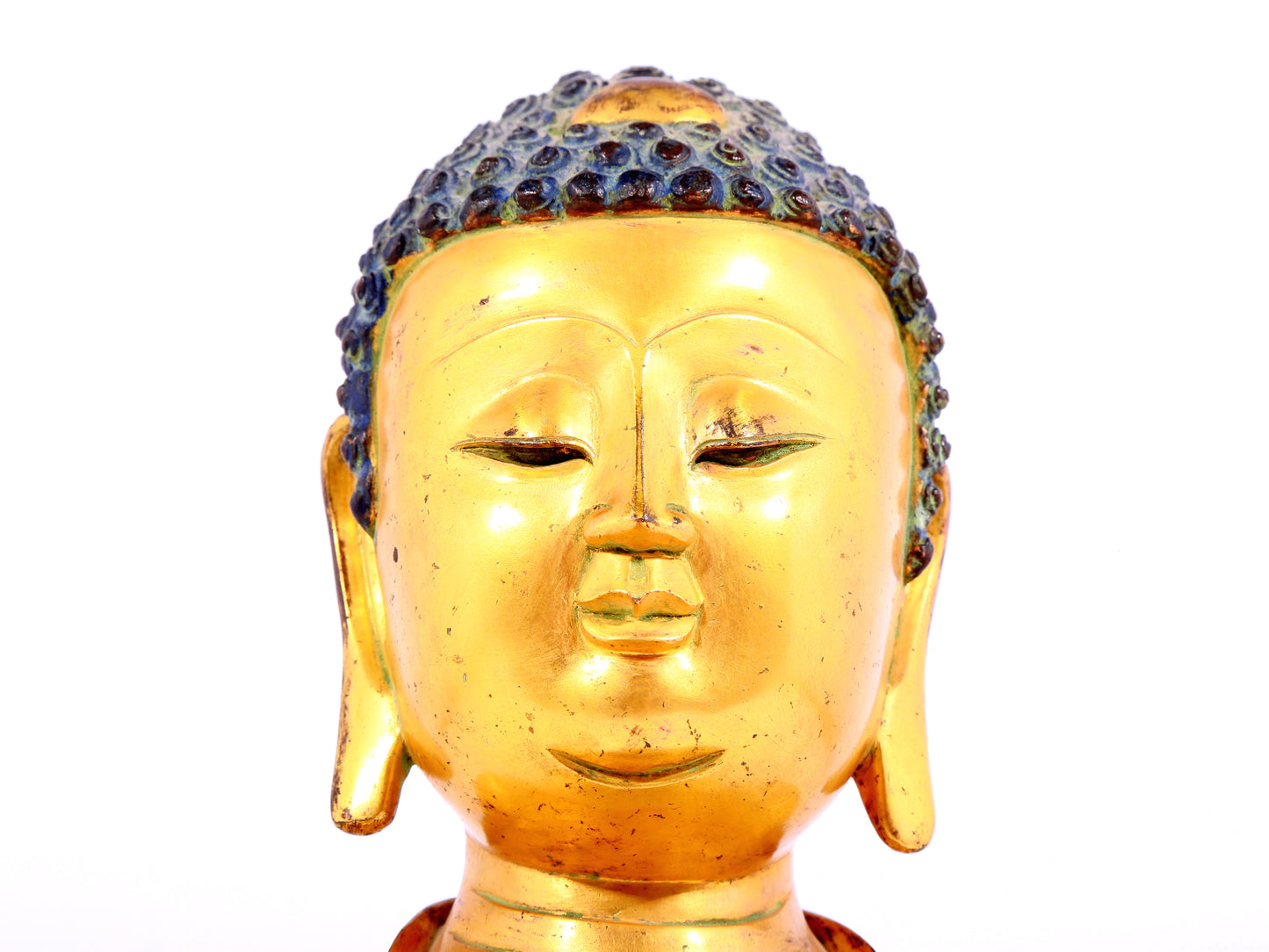 A solemn gilt bronze statue of Sakyamuni