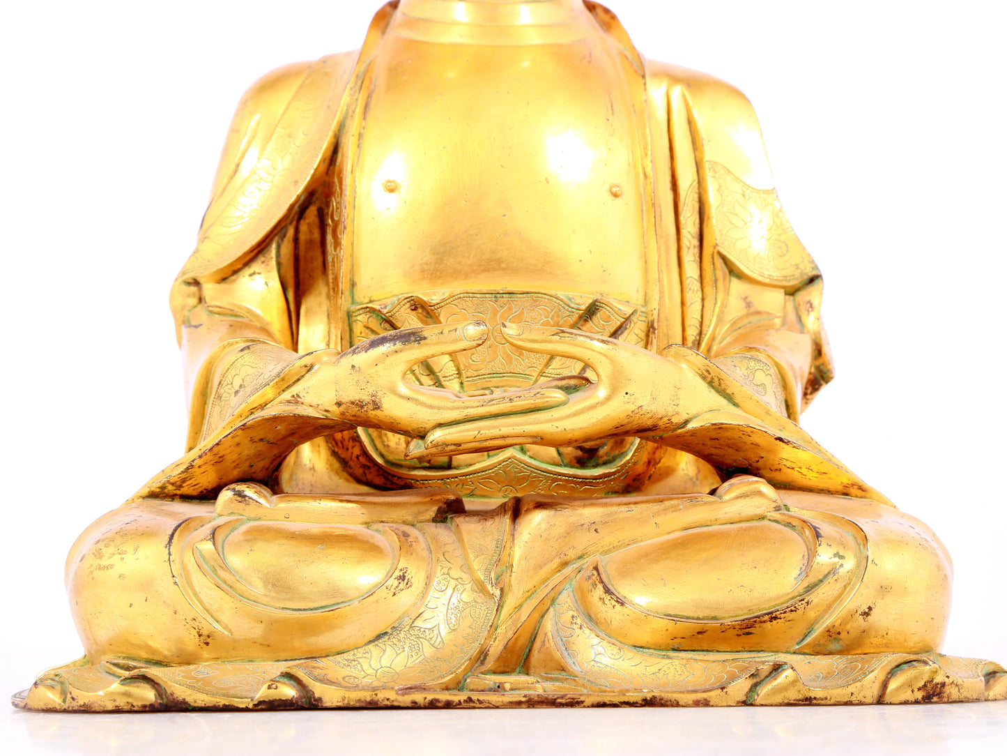 A solemn gilt bronze statue of Sakyamuni