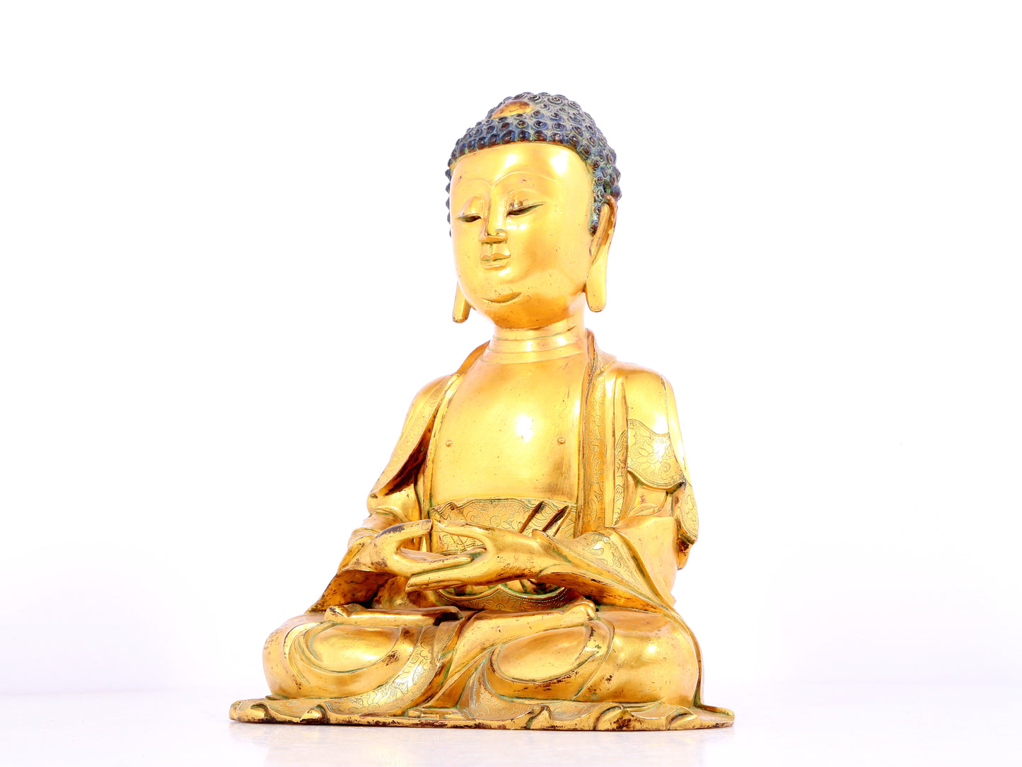 A solemn gilt bronze statue of Sakyamuni