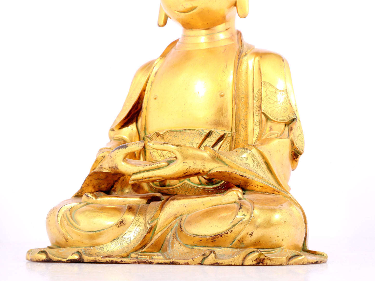 A solemn gilt bronze statue of Sakyamuni