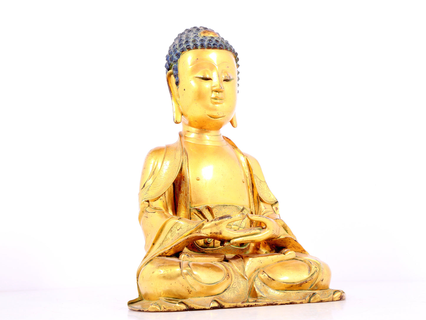 A solemn gilt bronze statue of Sakyamuni