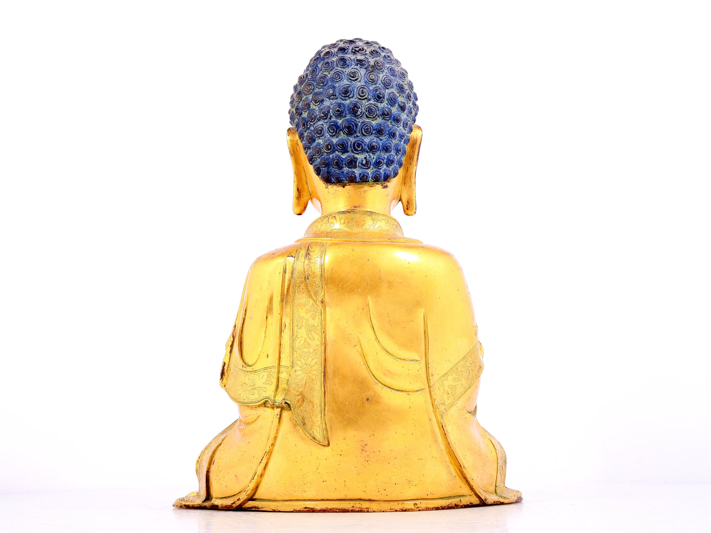 A solemn gilt bronze statue of Sakyamuni