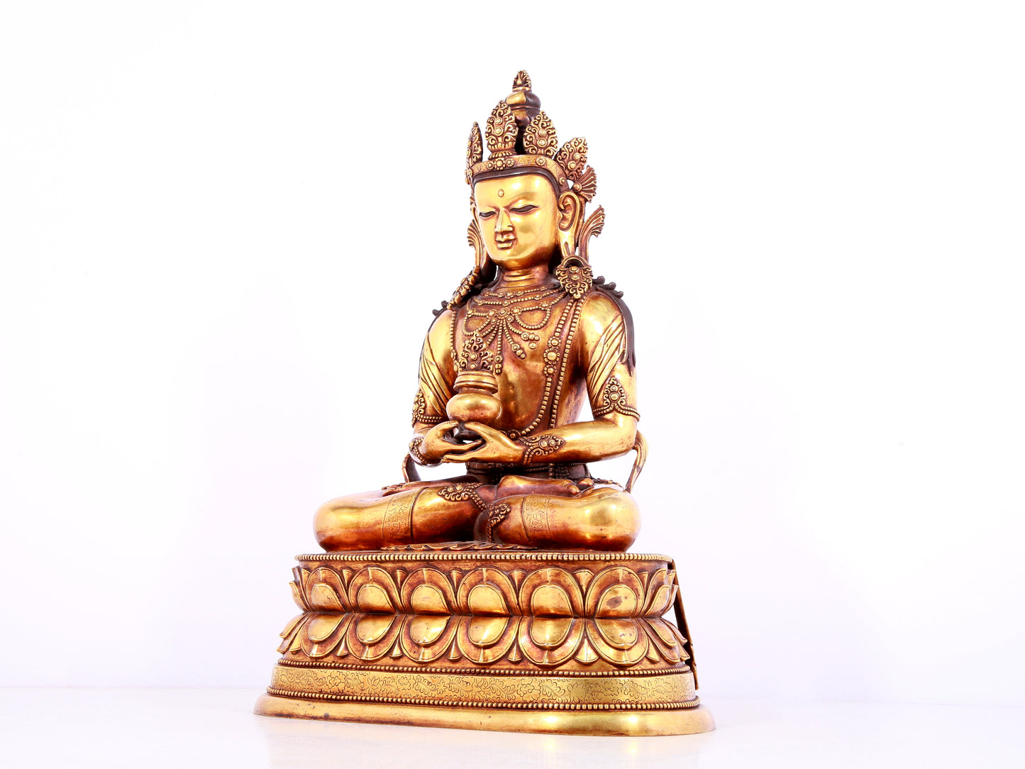 A solemn gilt bronze statue of Amitayus Buddha