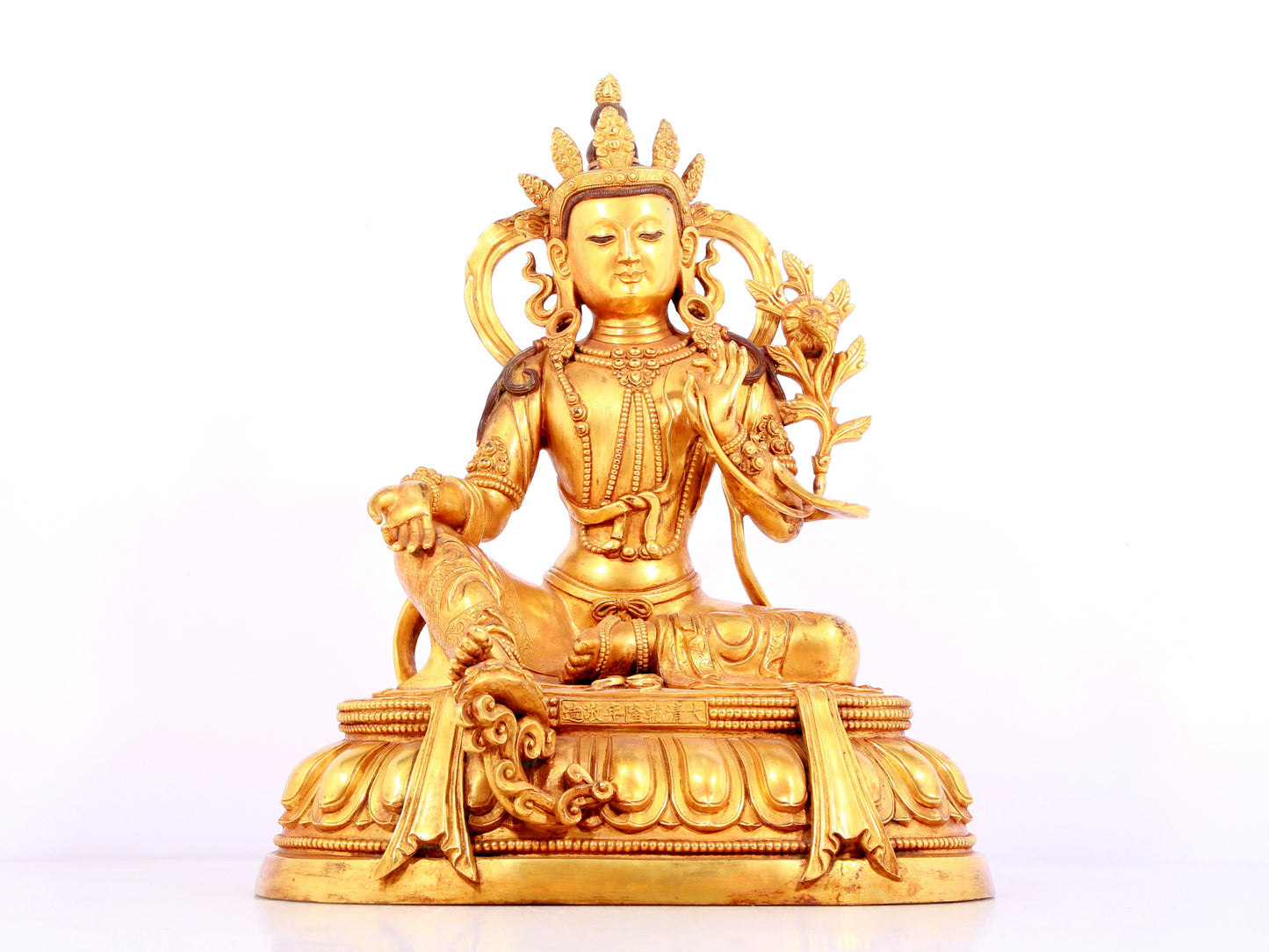 A solemn gilt bronze statue of green Tara