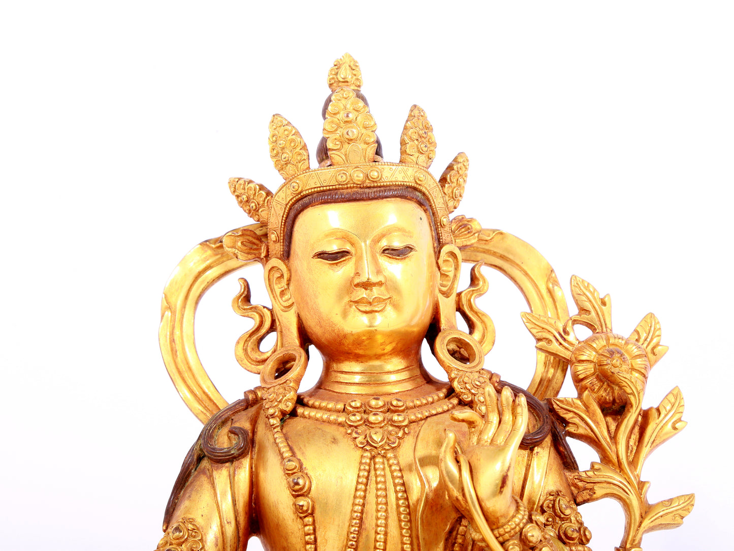 A solemn gilt bronze statue of green Tara