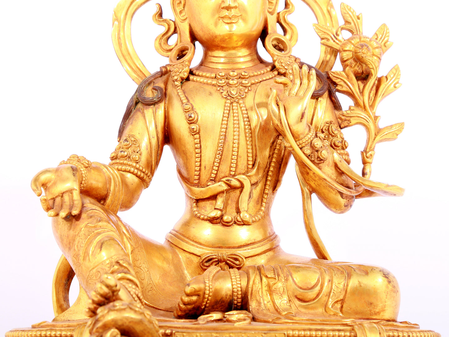 A solemn gilt bronze statue of green Tara