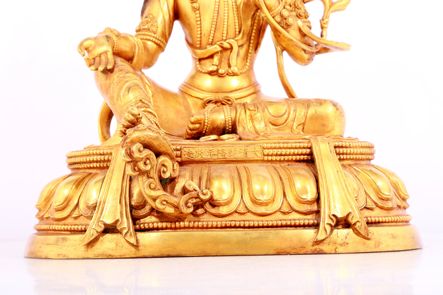 A solemn gilt bronze statue of green Tara