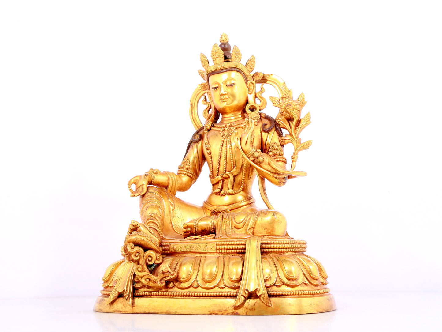 A solemn gilt bronze statue of green Tara