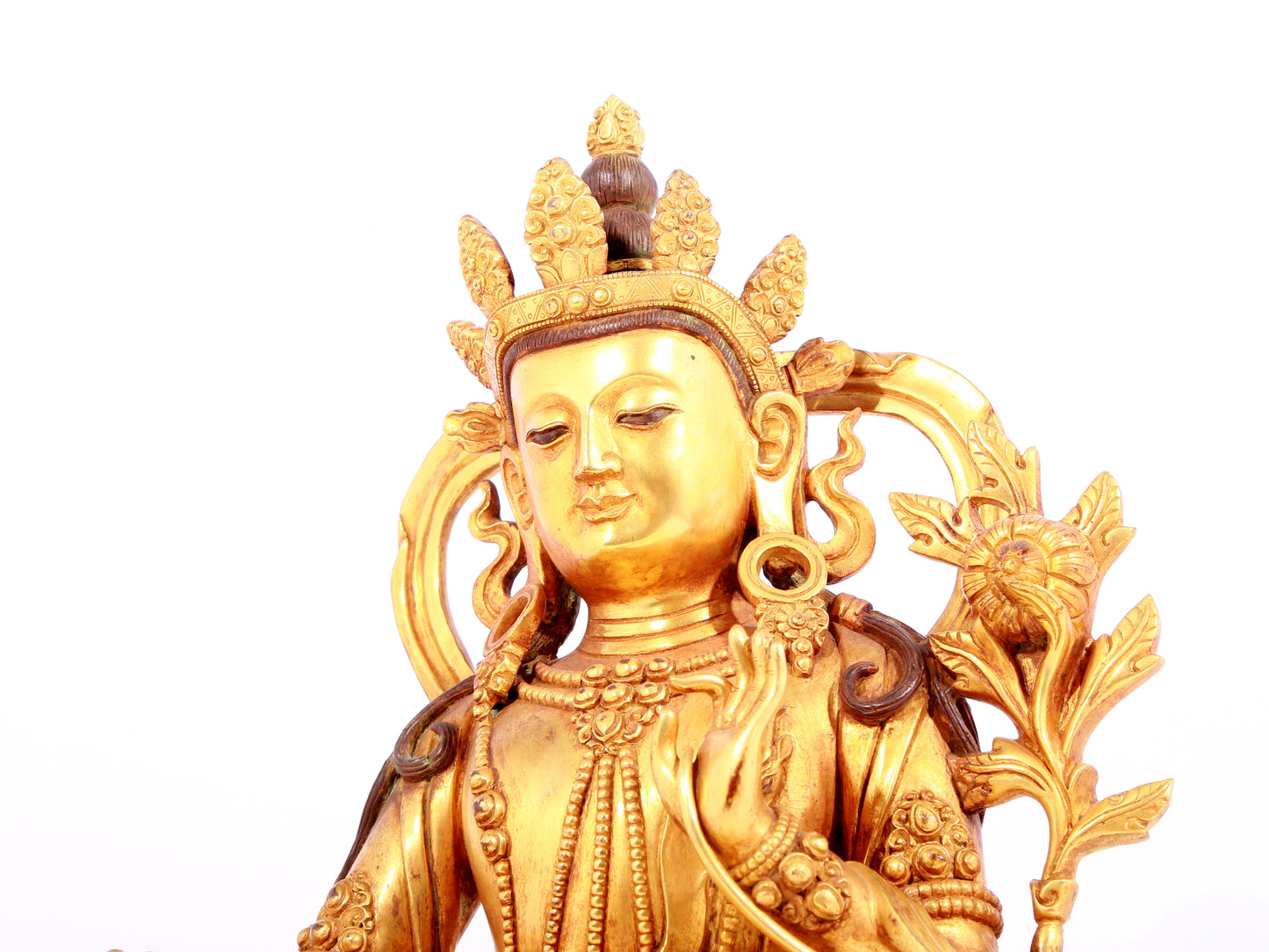 A solemn gilt bronze statue of green Tara