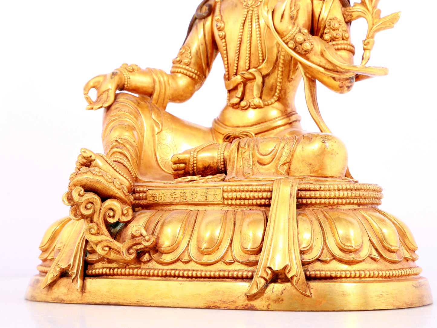 A solemn gilt bronze statue of green Tara