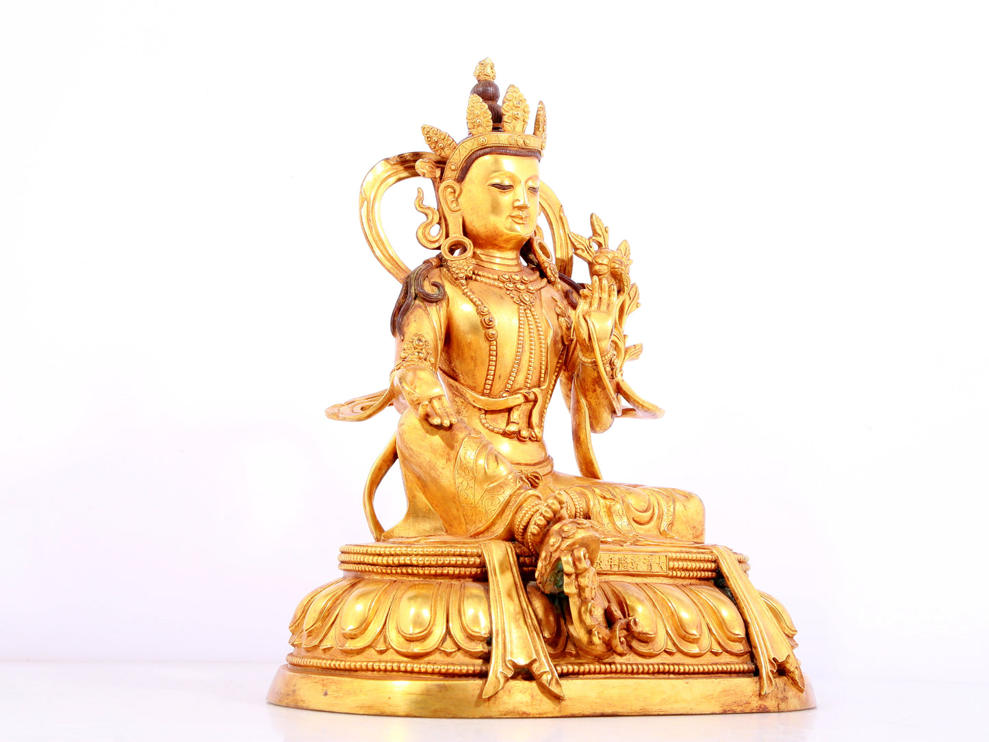 A solemn gilt bronze statue of green Tara