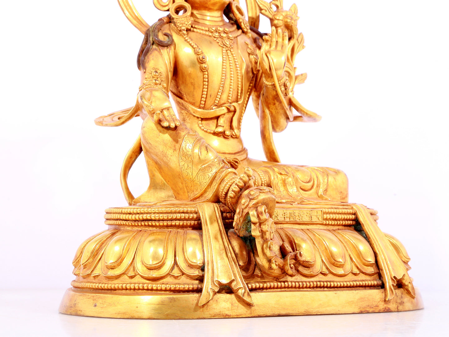 A solemn gilt bronze statue of green Tara