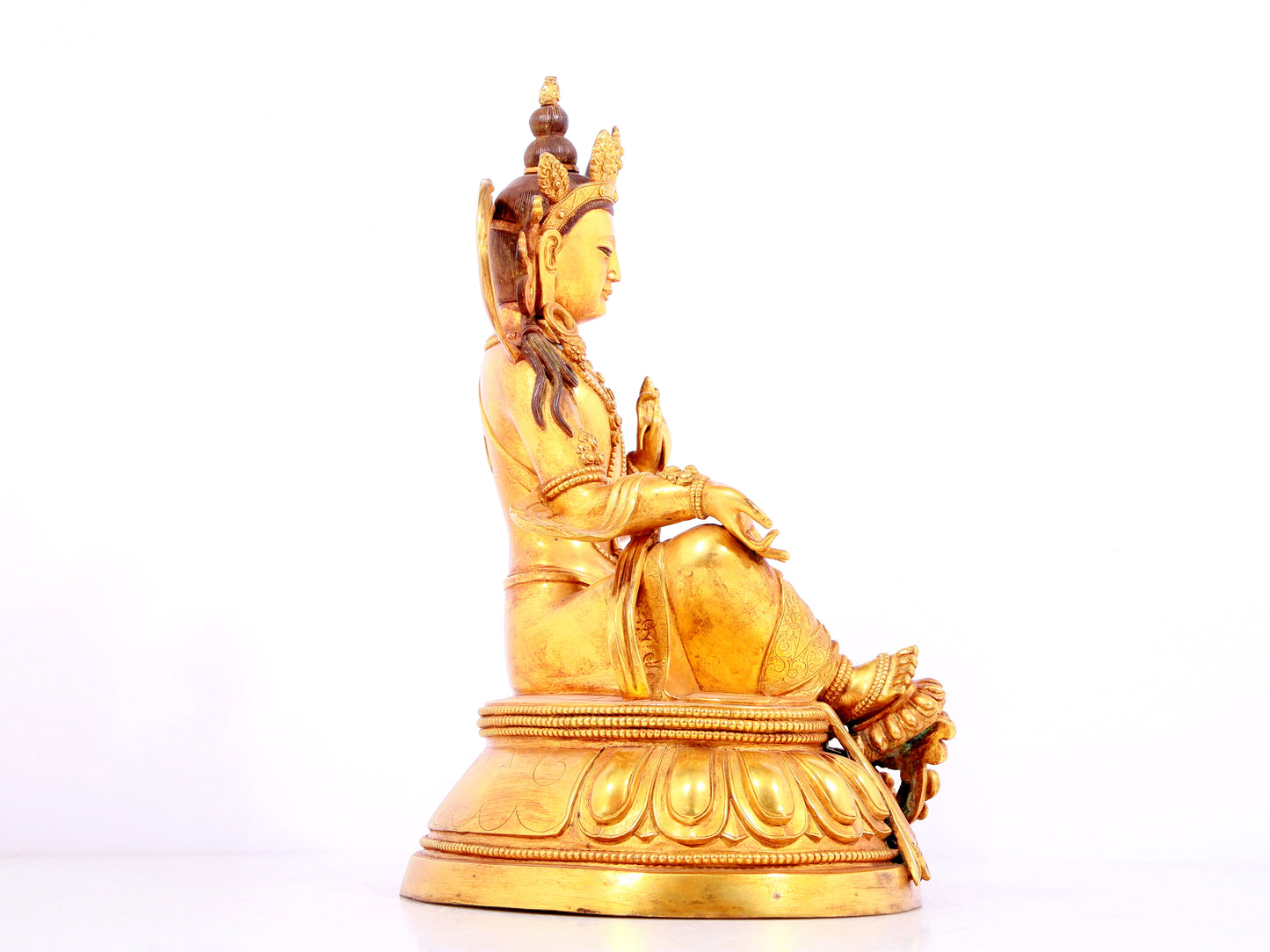 A solemn gilt bronze statue of green Tara