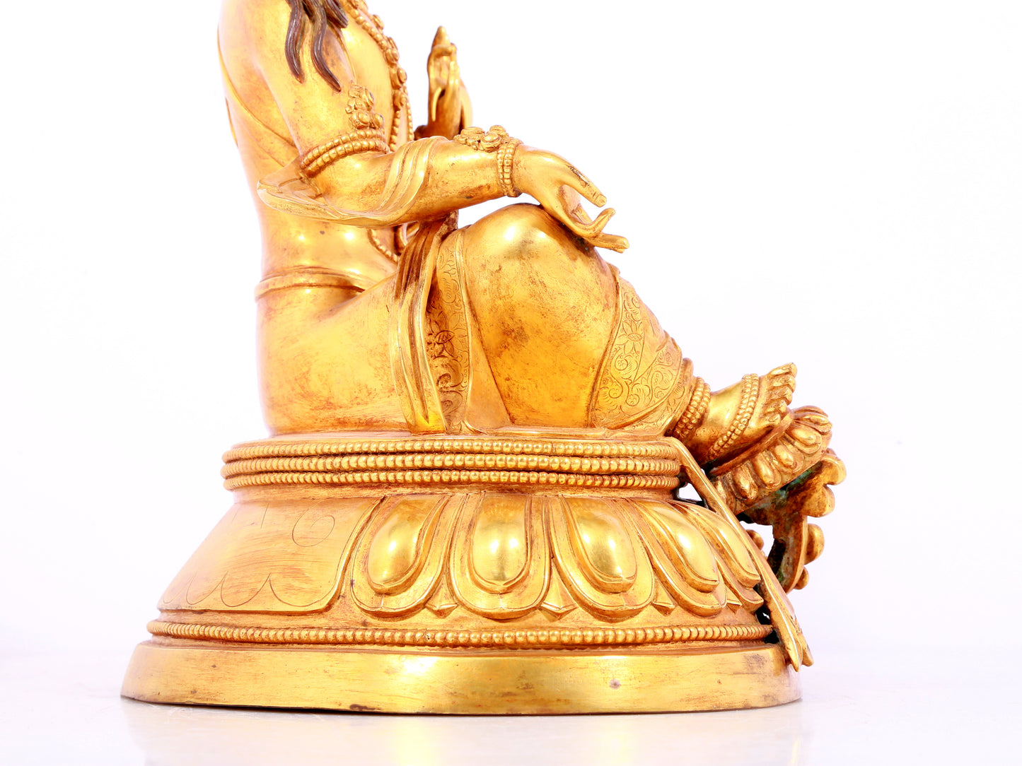 A solemn gilt bronze statue of green Tara