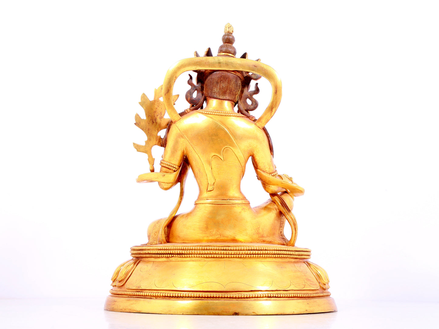 A solemn gilt bronze statue of green Tara