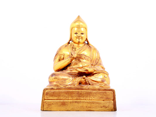 A solemn gilt bronze statue of Tsongkhapa