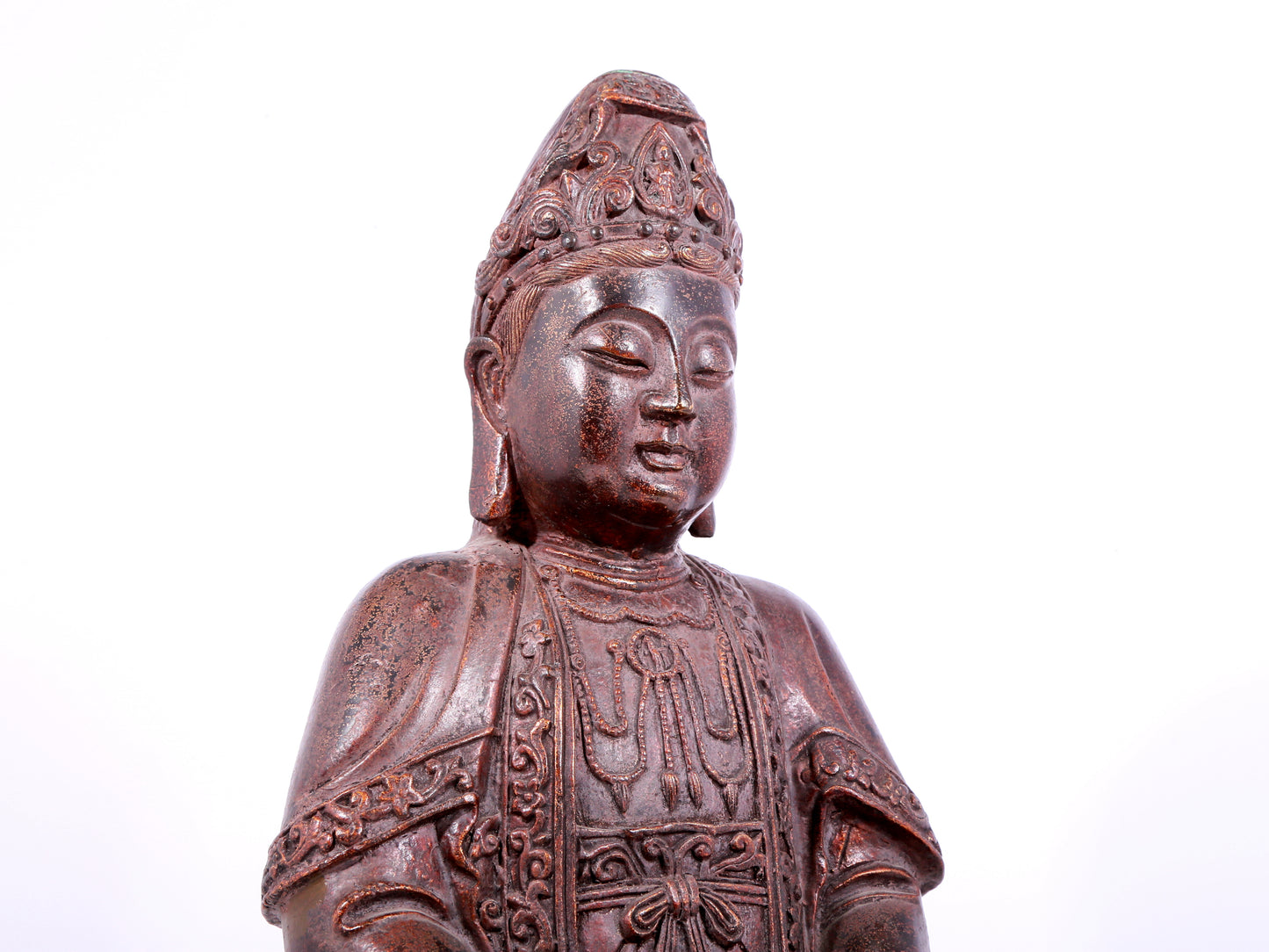 A solemn bronze Guanyin statue