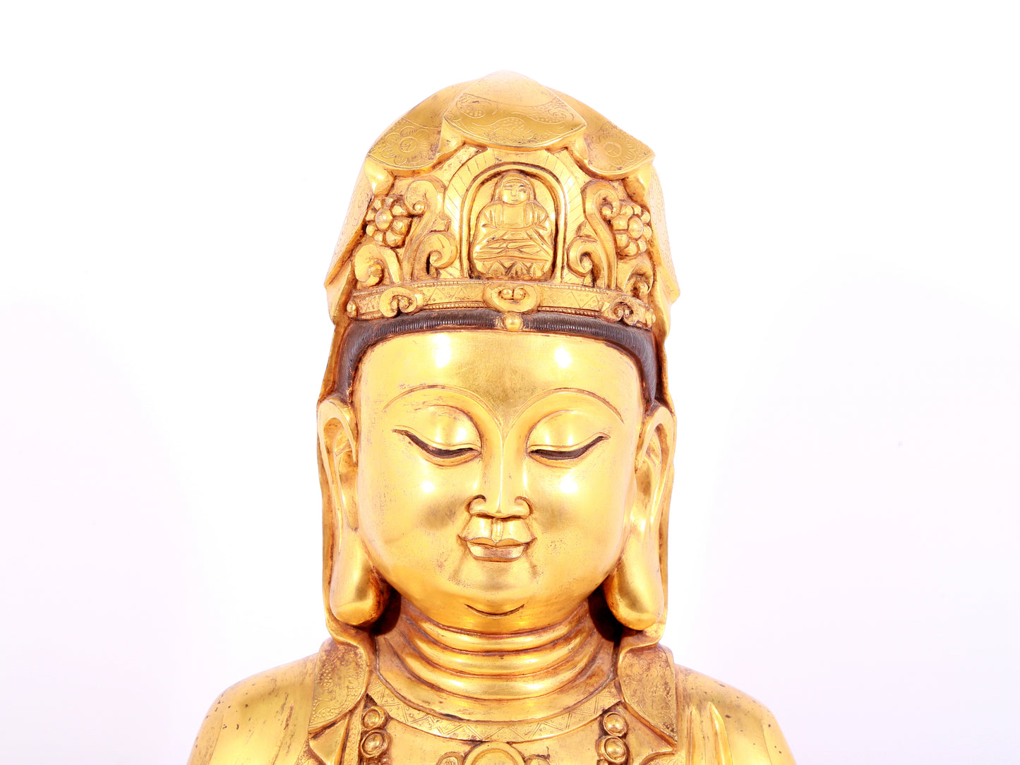 A solemn gilt bronze statue of Guanyin