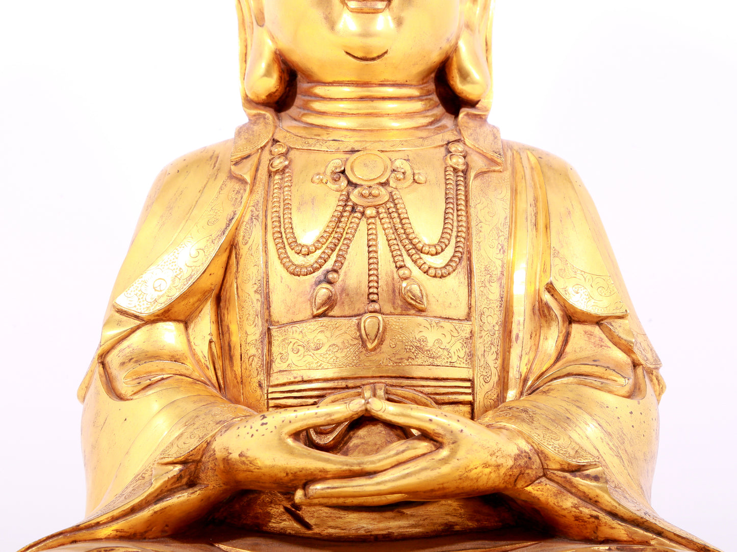 A solemn gilt bronze statue of Guanyin