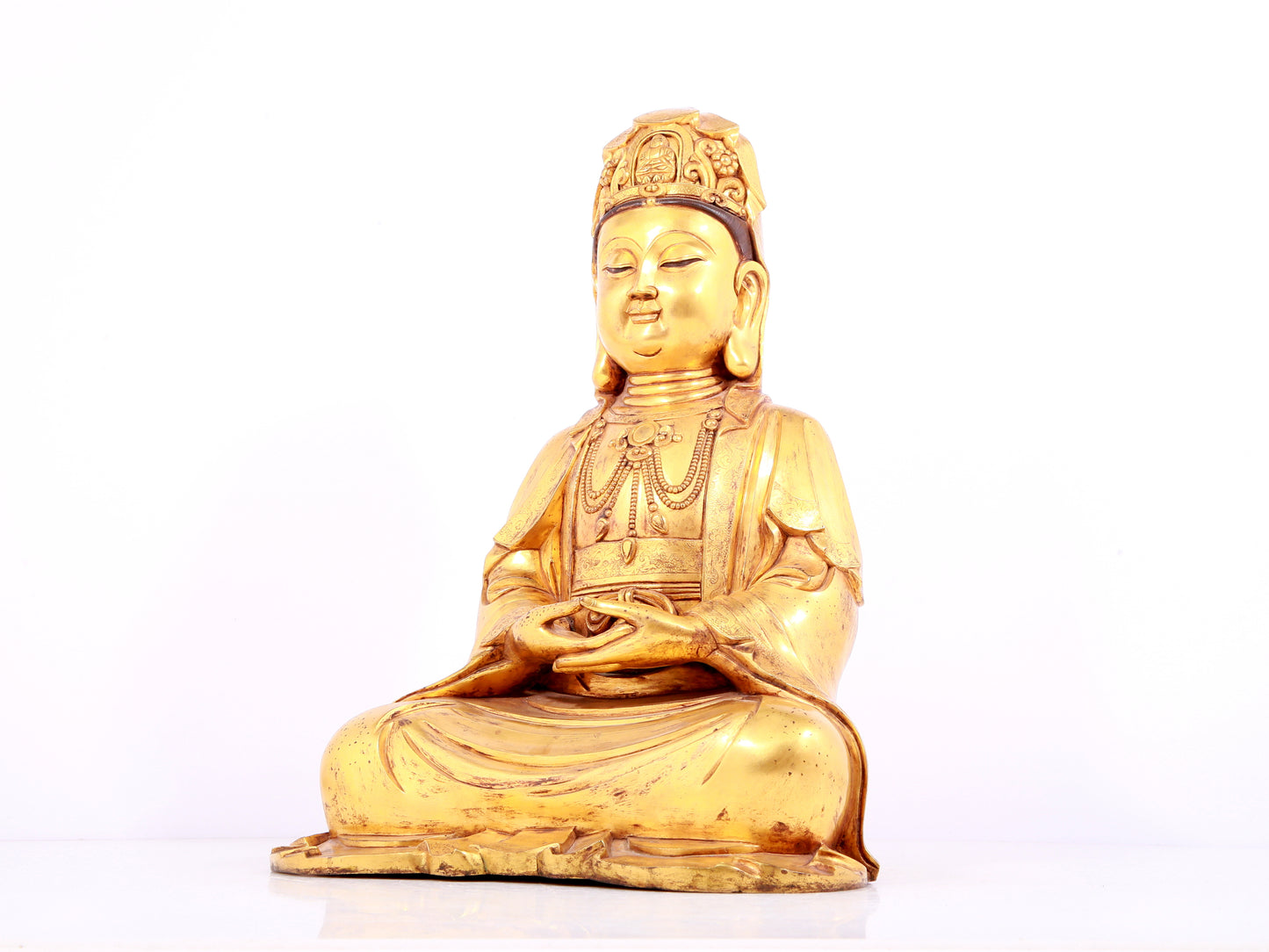 A solemn gilt bronze statue of Guanyin