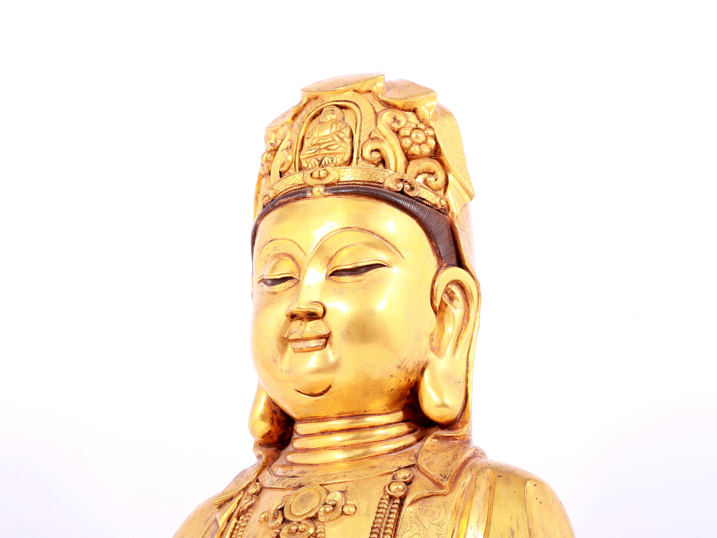 A solemn gilt bronze statue of Guanyin