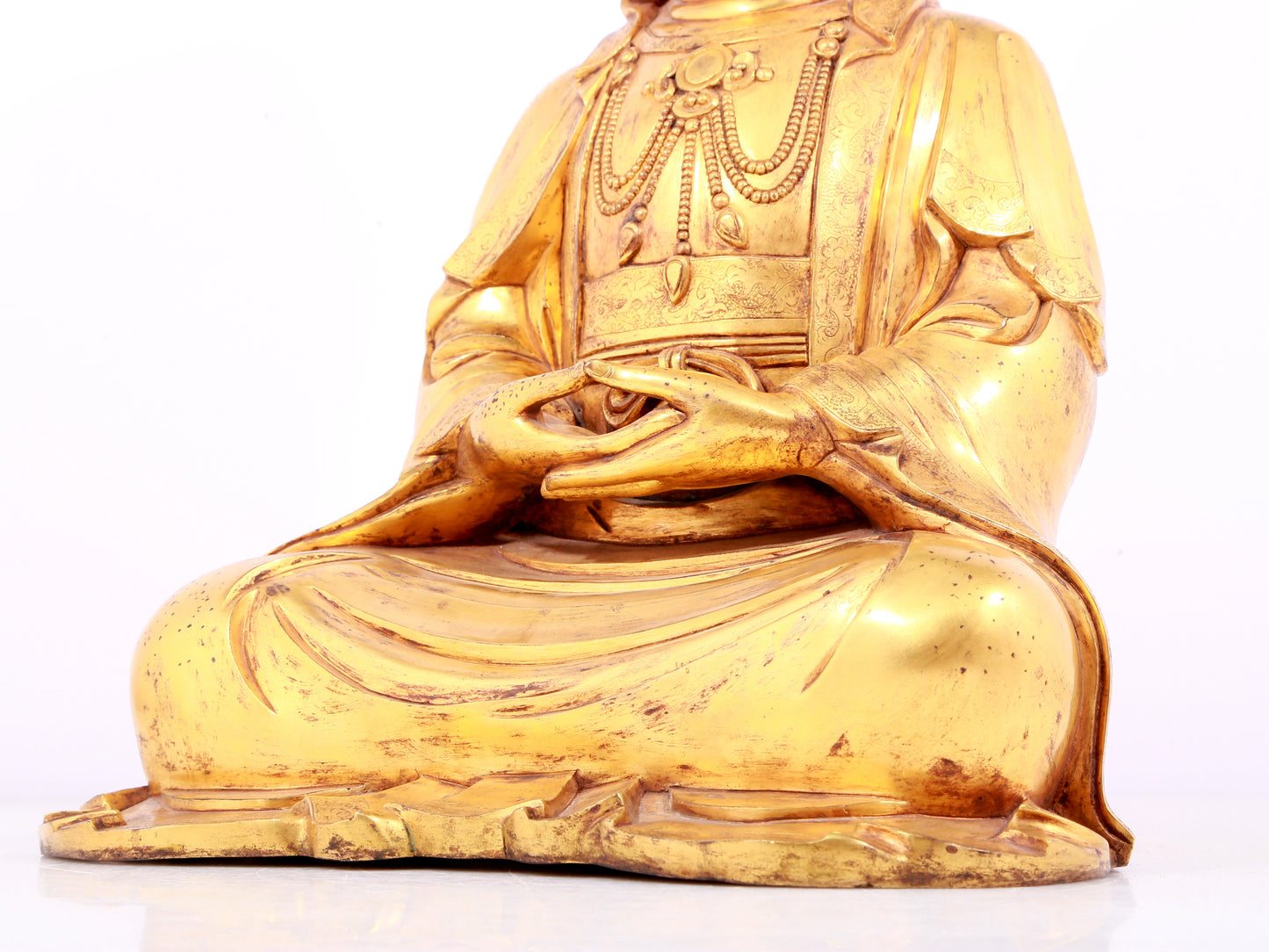 A solemn gilt bronze statue of Guanyin