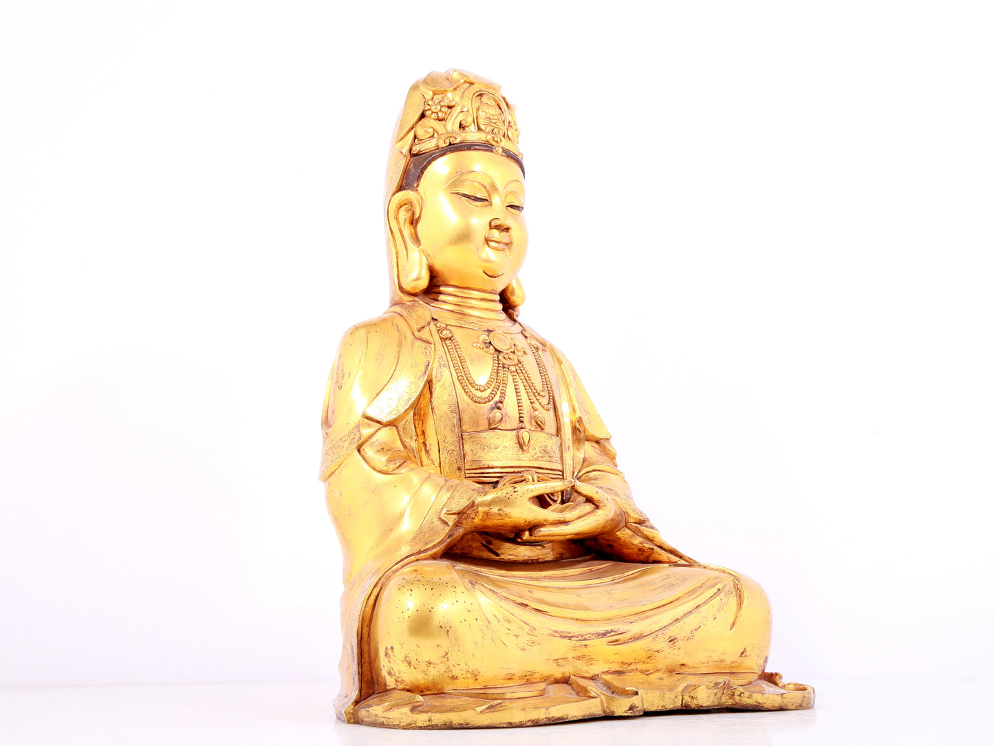 A solemn gilt bronze statue of Guanyin